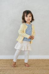 Toddler outfit with Avauma ribbed yellow cardigan, layered with baby blue knit top and cream ruffle skirt Toddler outfit with Avauma ribbed yellow cardigan, layered with baby blue knit top and cream ruffle skirt