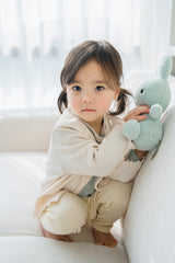 Baby girl in Avauma off white cardigan with floral print outfit, soft spring style Baby girl in Avauma off white cardigan with floral print outfit, soft spring style