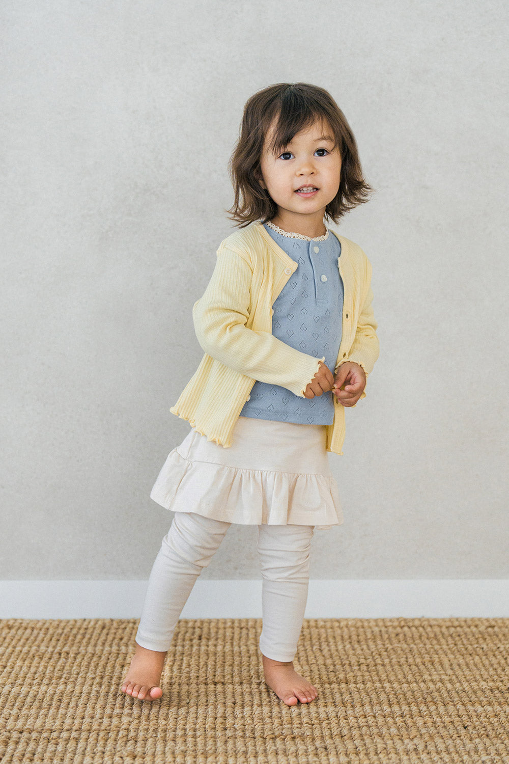 Side view of toddler in Avauma milky white skirt leggings paired with a light pastel blouse โ elegant and comfortable infant outfit
 Side view of toddler in Avauma milky white skirt leggings paired with a light pastel blouse โ elegant and comfortable infant outfit
