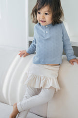 Side view of toddler in Avauma milky white skirt leggings paired with a light pastel blouse โ elegant and comfortable infant outfit
 Side view of toddler in Avauma milky white skirt leggings paired with a light pastel blouse โ elegant and comfortable infant outfit