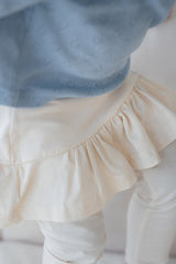 Close-up of Avauma milky white skirt leggings, showcasing soft cotton fabric and gentle ruffle finish โ perfect baby fashion piece Close-up of Avauma milky white skirt leggings, showcasing soft cotton fabric and gentle ruffle finish โ perfect baby fashion piece