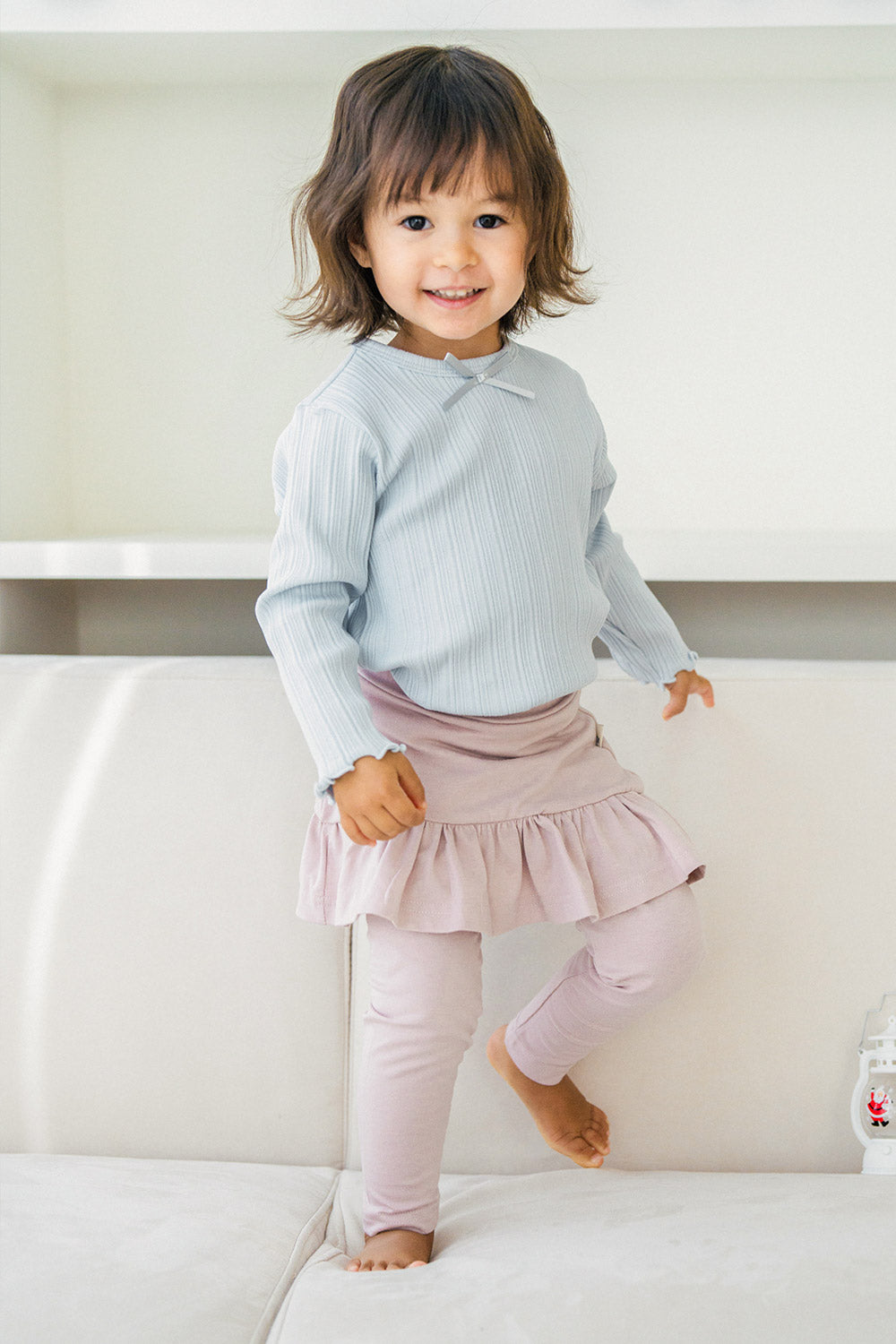 Toddler girl wearing Avauma powder pink ruffle skirt leggings and light blue ribbed top โ soft baby clothing outfit Toddler girl wearing Avauma powder pink ruffle skirt leggings and light blue ribbed top โ soft baby clothing outfit
