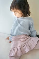 Close-up of Avauma baby skirt leggings with soft ruffle detail in powder pink โ comfortable cotton toddler outfit Close-up of Avauma baby skirt leggings with soft ruffle detail in powder pink โ comfortable cotton toddler outfit