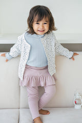 Smiling toddler girl wearing Avauma baby skirt leggings in powder pink and floral cardigan โ cute spring outfit Smiling toddler girl wearing Avauma baby skirt leggings in powder pink and floral cardigan โ cute spring outfit