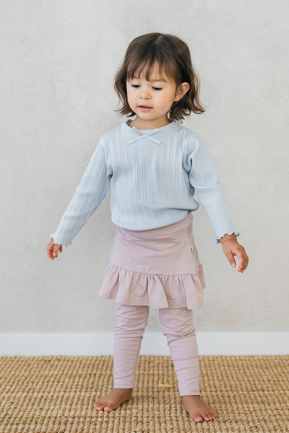 Full-body view of toddler wearing Avauma ruffled skirt leggings in powder pink โ sweet and comfy baby outfit Full-body view of toddler wearing Avauma ruffled skirt leggings in powder pink โ sweet and comfy baby outfit
