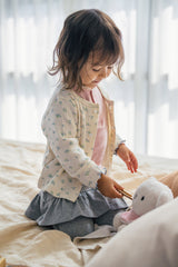 Baby girl playing on bed in Avauma silver misk ruffle skirt leggings โ perfect cozy outfit for active toddlers Baby girl playing on bed in Avauma silver misk ruffle skirt leggings โ perfect cozy outfit for active toddlers