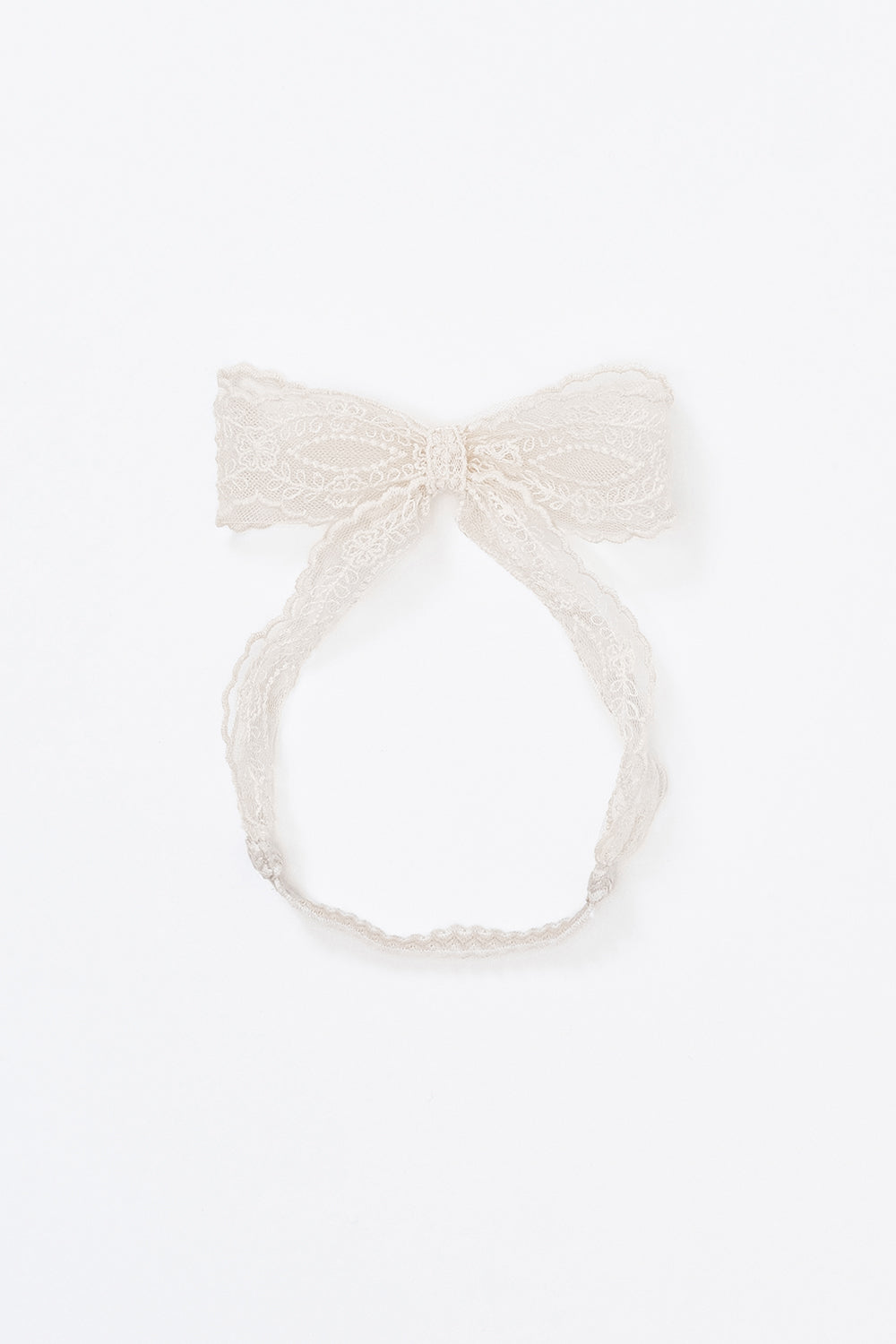 Avauma ivory lace ribbon headband laid flat on white background Avauma ivory lace ribbon headband laid flat on white background