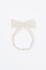 Avauma ivory lace ribbon headband laid flat on white background Avauma ivory lace ribbon headband laid flat on white background