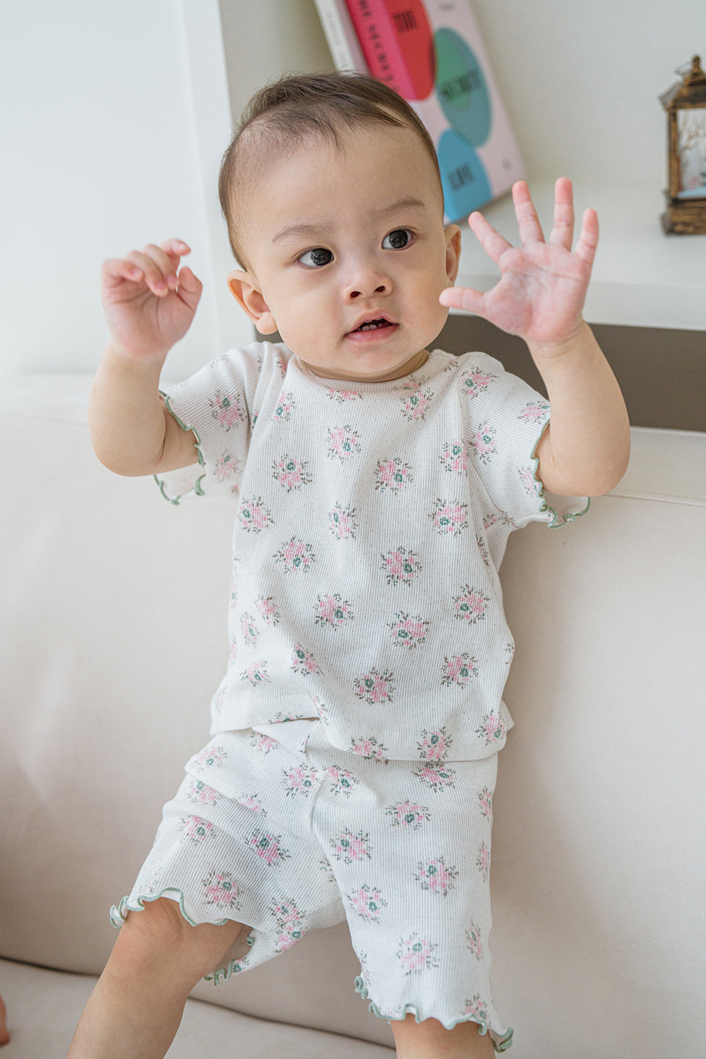Close-up of Creamy Buquet floral baby clothes, ruffle hem and soft ribbed cotton fabric by Avauma Close-up of Creamy Buquet floral baby clothes, ruffle hem and soft ribbed cotton fabric by Avauma