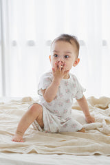 Baby in Sienna Rose Creamy Buquet set, sitting on bed with plush toy, vintage floral summer babywear Baby in Sienna Rose Creamy Buquet set, sitting on bed with plush toy, vintage floral summer babywear