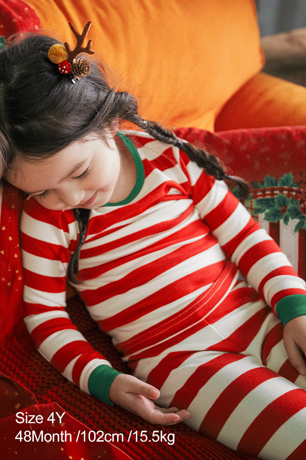 Close-up of child wearing AVAUMA Holiday Long Sleeve Pajama Set - Jolly Stripe Greencuff, red and white striped patter