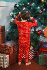 Child decorating Christmas tree, wearing AVAUMA Holiday Long Sleeve Pajama Set - Snowflake

