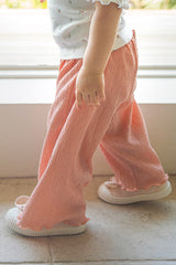 Toddler girl wearing Avauma Rosevale pleated summer pants indoors