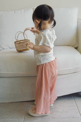 Baby girl wearing Avauma Rosevale lightweight pleats pants