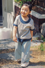 Toddler girl wearing Avauma Sky Blue pleats pants outdoors