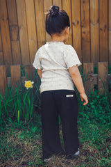 Back view of Avauma Soft Black pleated summer pants for toddlers