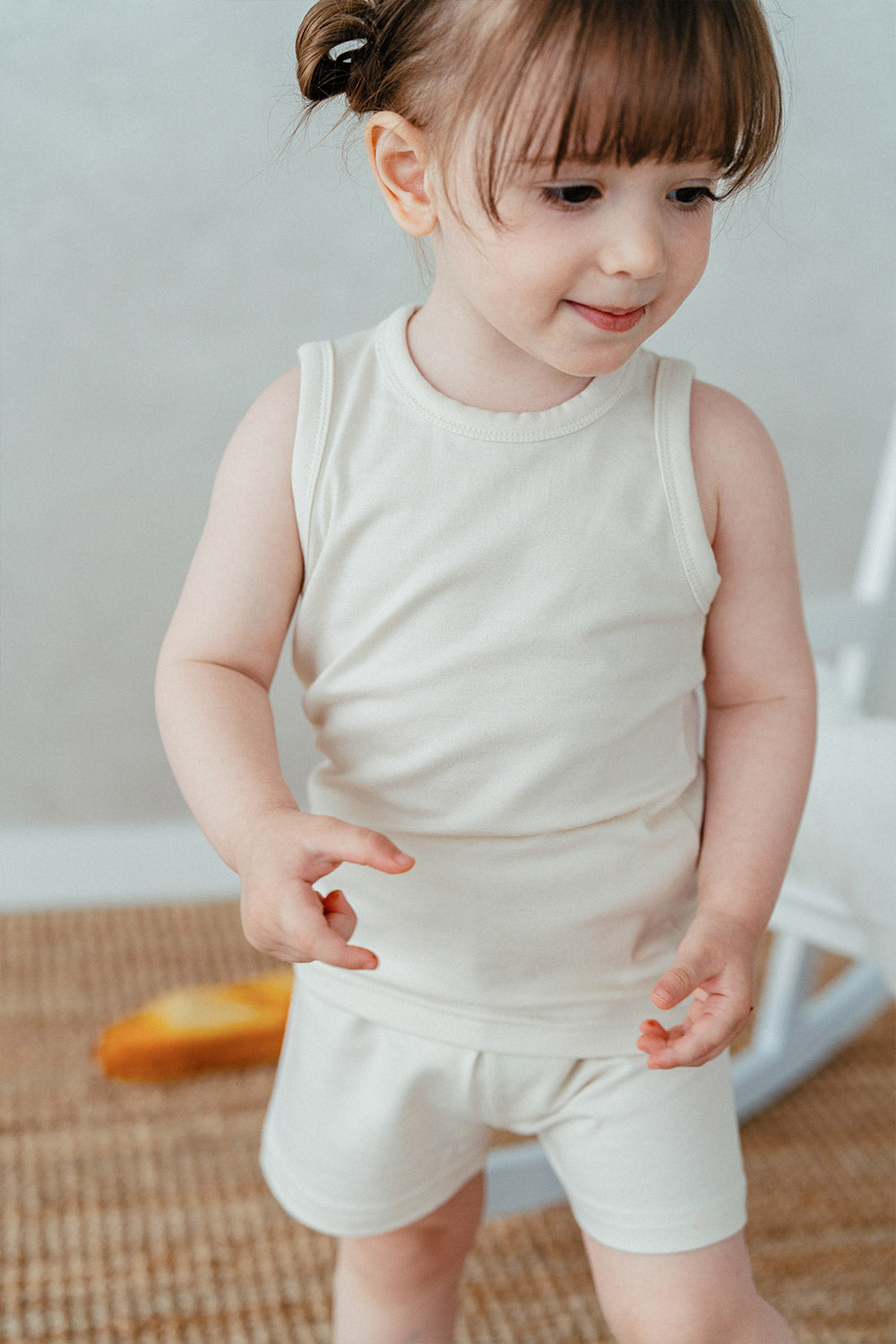 Modal Cool Comfort Tank Set - Cream. The Modal Cool Comfort Tank Set is crafted from a premium blend of modal and cotton, offering both softness and coziness. It's perfect for kids to wear comfortably while playing with friends at the playground. Even with lots of sweating, it keeps them feeling fresh for longer periods.