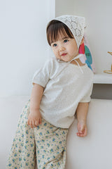 Toddler wearing milk pearl short sleeve baby shirt with lace trim and floral pants, tilting head – Avauma

