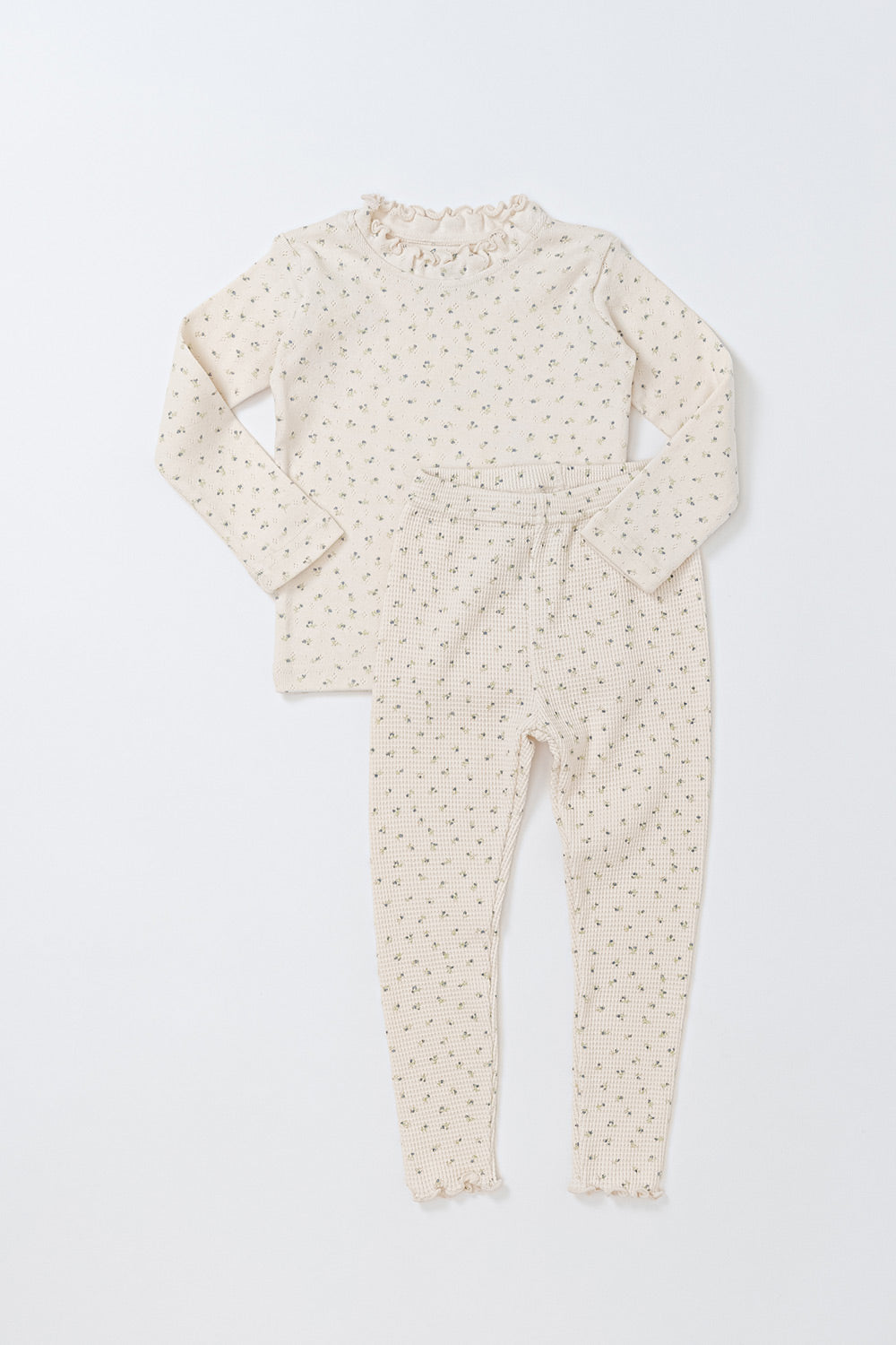 Avauma Eyelet Bloom Long Sleeve Setup Pajamas - Creamy Flower, featuring a delicate floral print on a soft cream-colored top and bottom set, perfect for cozy baby sleepwear.