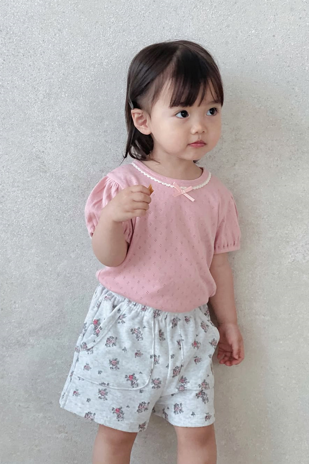 Toddler Girl Wearing Avauma Fluffy Garden Cream Rose Baby Shorts, Matched with Pink T-Shirt

