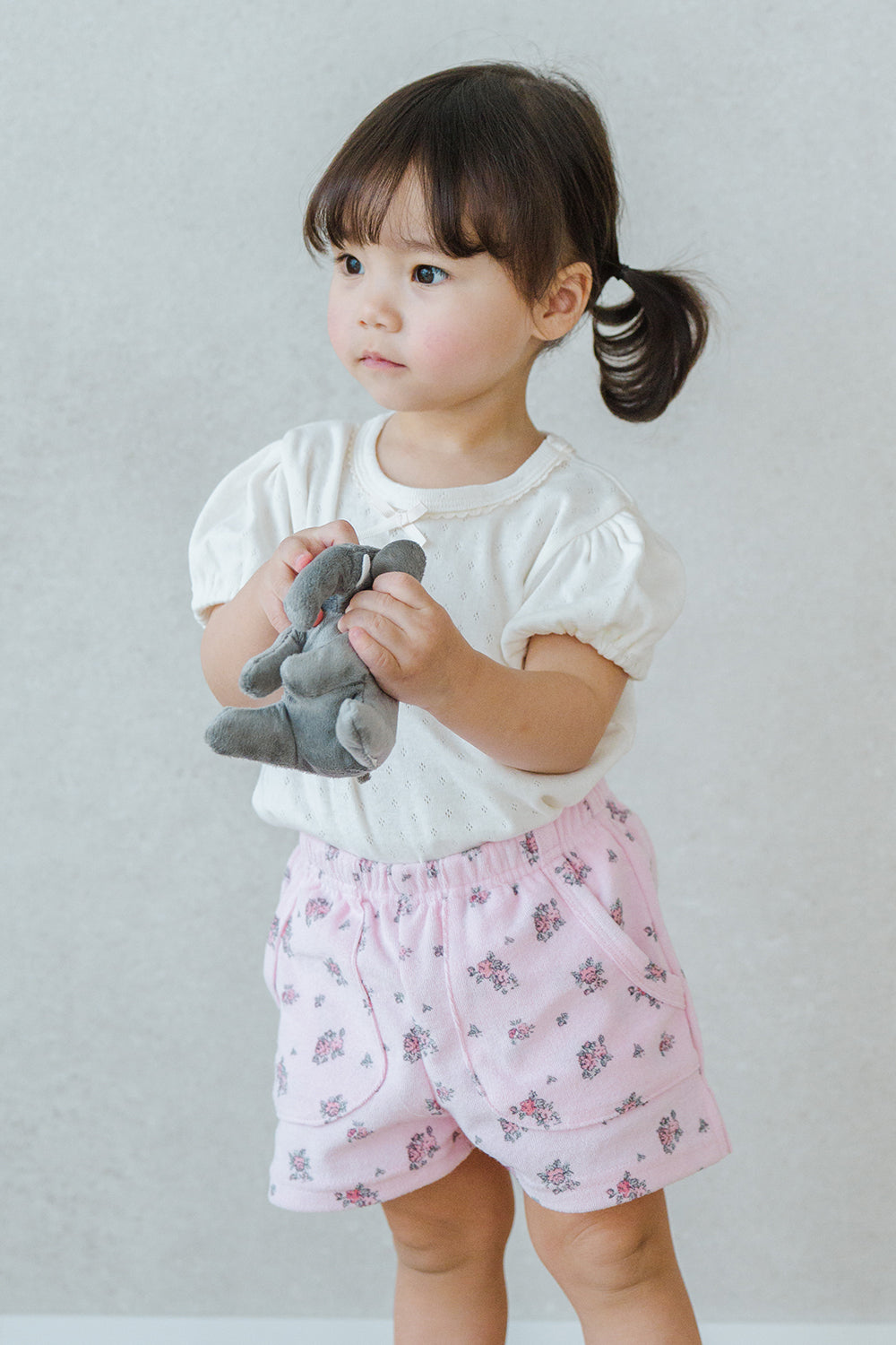 Toddler Girl Holding Plush Toy in Avauma Fluffy Garden Peach Mood Baby Shorts, Lightweight and Cute Summer Wear

