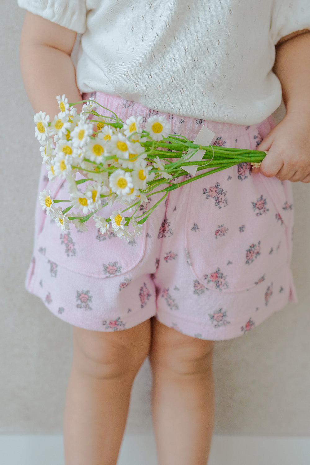 Close-up of Avauma Fluffy Garden Peach Mood Baby Shorts, Delicate Rose Pattern on Soft Ribbed Fabric

