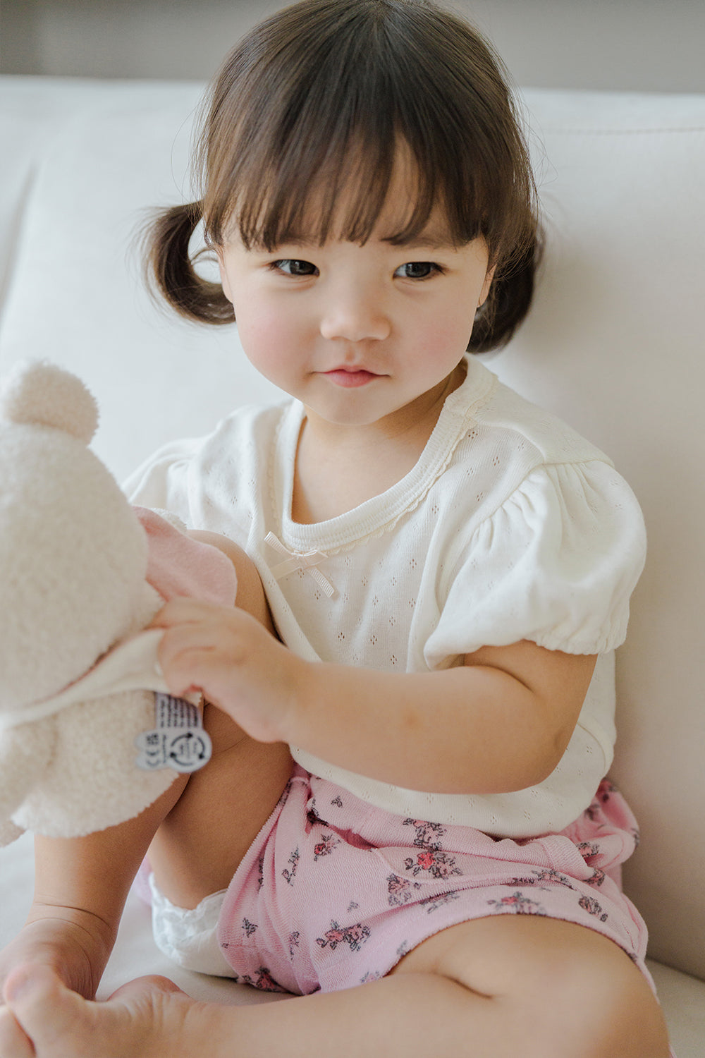 Toddler Sitting in Avauma Fluffy Garden Peach Mood Baby Shorts, Breathable and Comfy Summer Outfit

