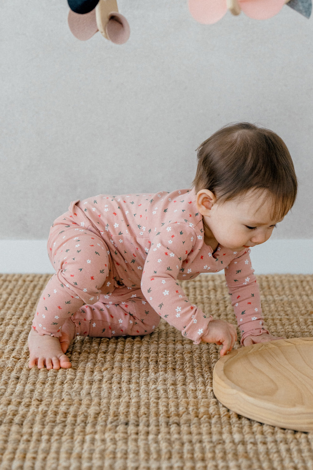 Baby crawling in Avauma Mini Fleur Long Sleeve Set - Frill Ellapink, a comfortable and adorable floral pink sleepwear set with frill details.