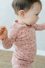 Baby wearing Avauma Mini Fleur Long Sleeve Set - Frill Ellapink, showing the pink floral patterned pajamas with delicate frill details, ideal for cozy sleepwear.