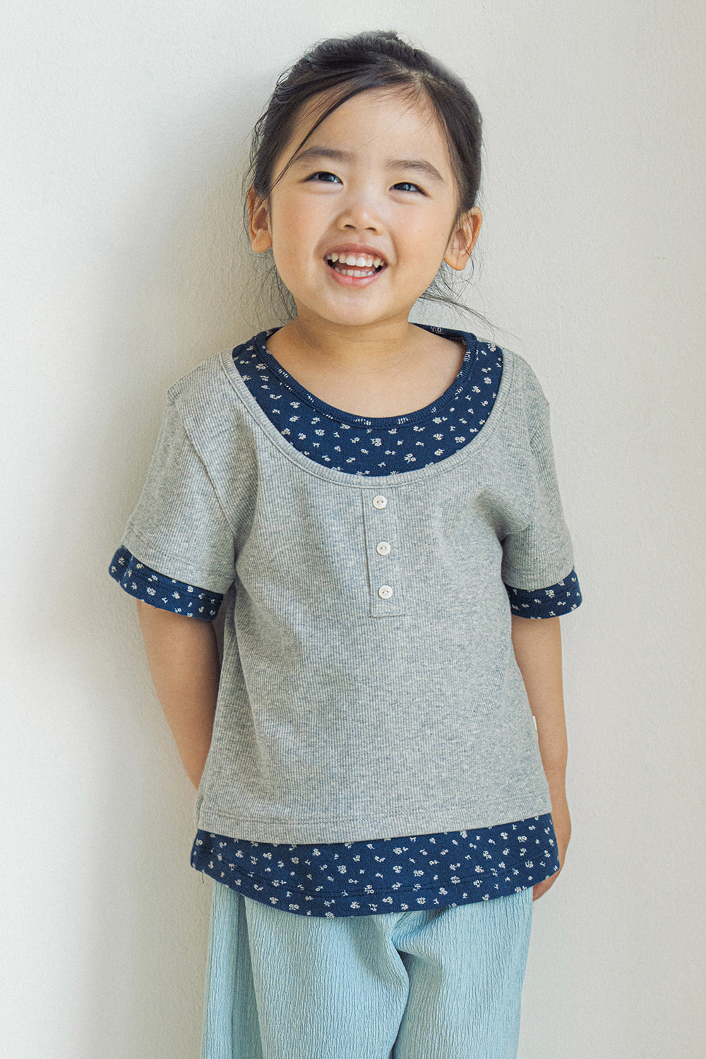 Toddler girl wearing Avauma Melange Navy floral layered summer tee