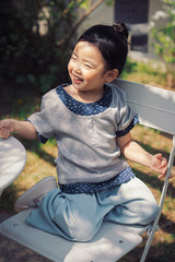 Baby girl wearing Avauma Melange Navy ribbed floral tee outdoors