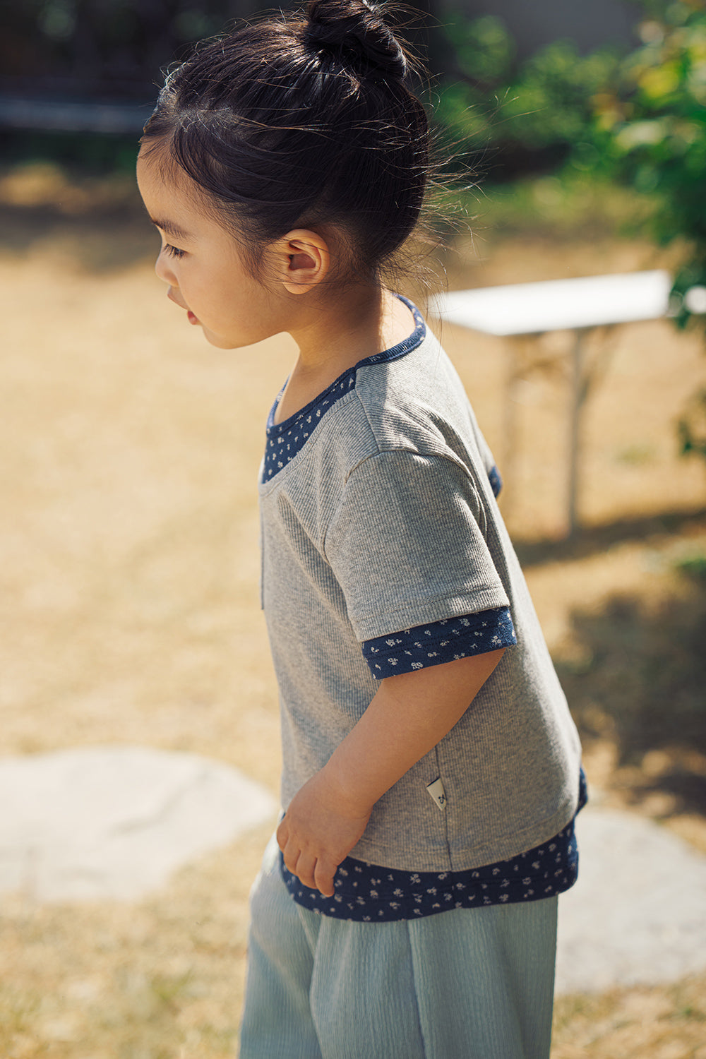 Side profile of Avauma Melange Navy floral layered tee for toddlers