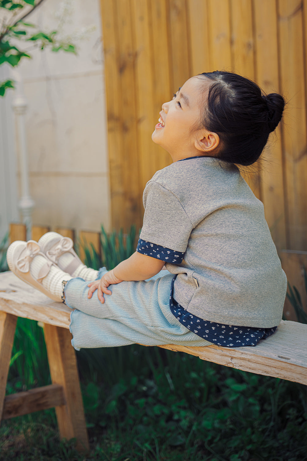 Toddler girl sitting outdoors wearing Avauma Melange Navy summer outfit

