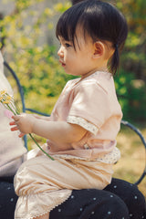 Side view of Avauma Pink Ivory toddler summer outfit outdoors
