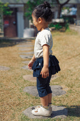 Side view of a toddler in Avauma deep navy skirted leggings, stylish tiered ruffle design for active 1-3 year olds.