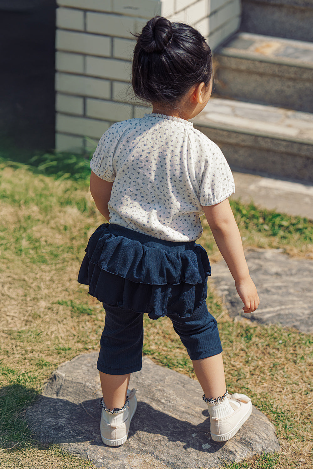 Rear view of Avauma toddler skirted leggings in navy, showing the multi-layered ruffle skirt and high-quality 100% cotton fabric.