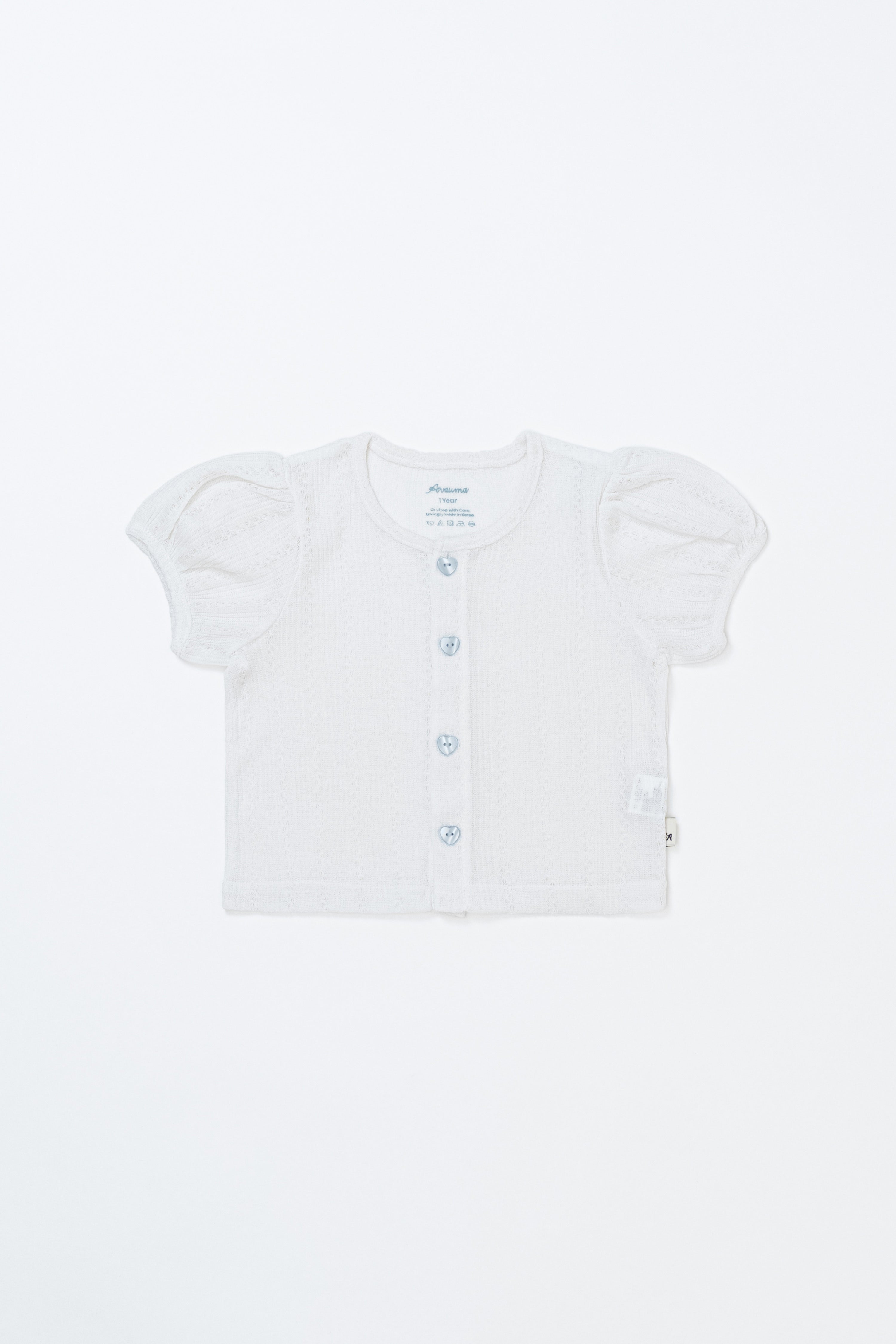Flat lay of Avauma Buttercumin cardigan in cotton ivory with puff sleeves.