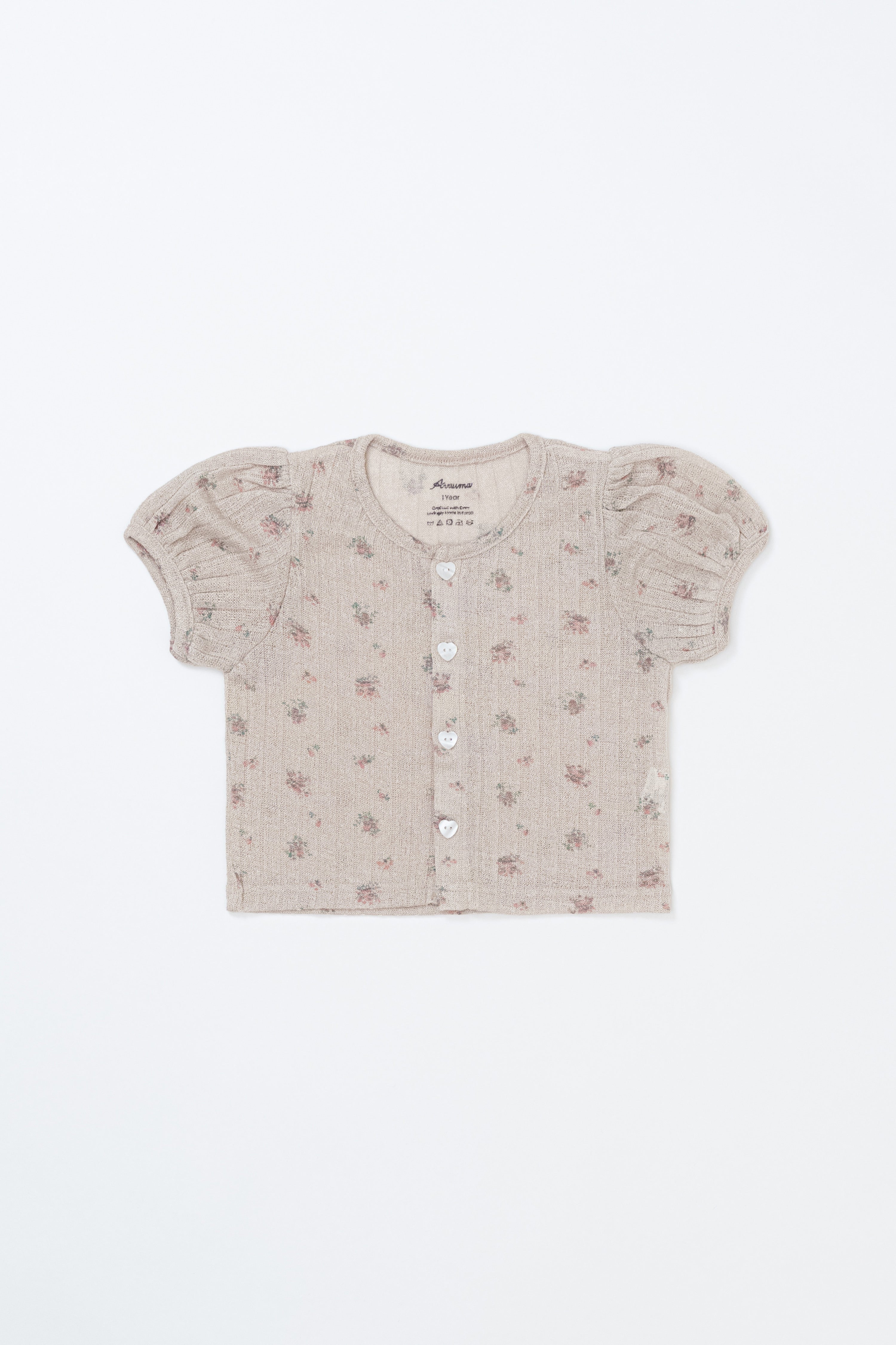 Flat lay of Avauma Buttercumin cardigan in sand floral with puff sleeves.

