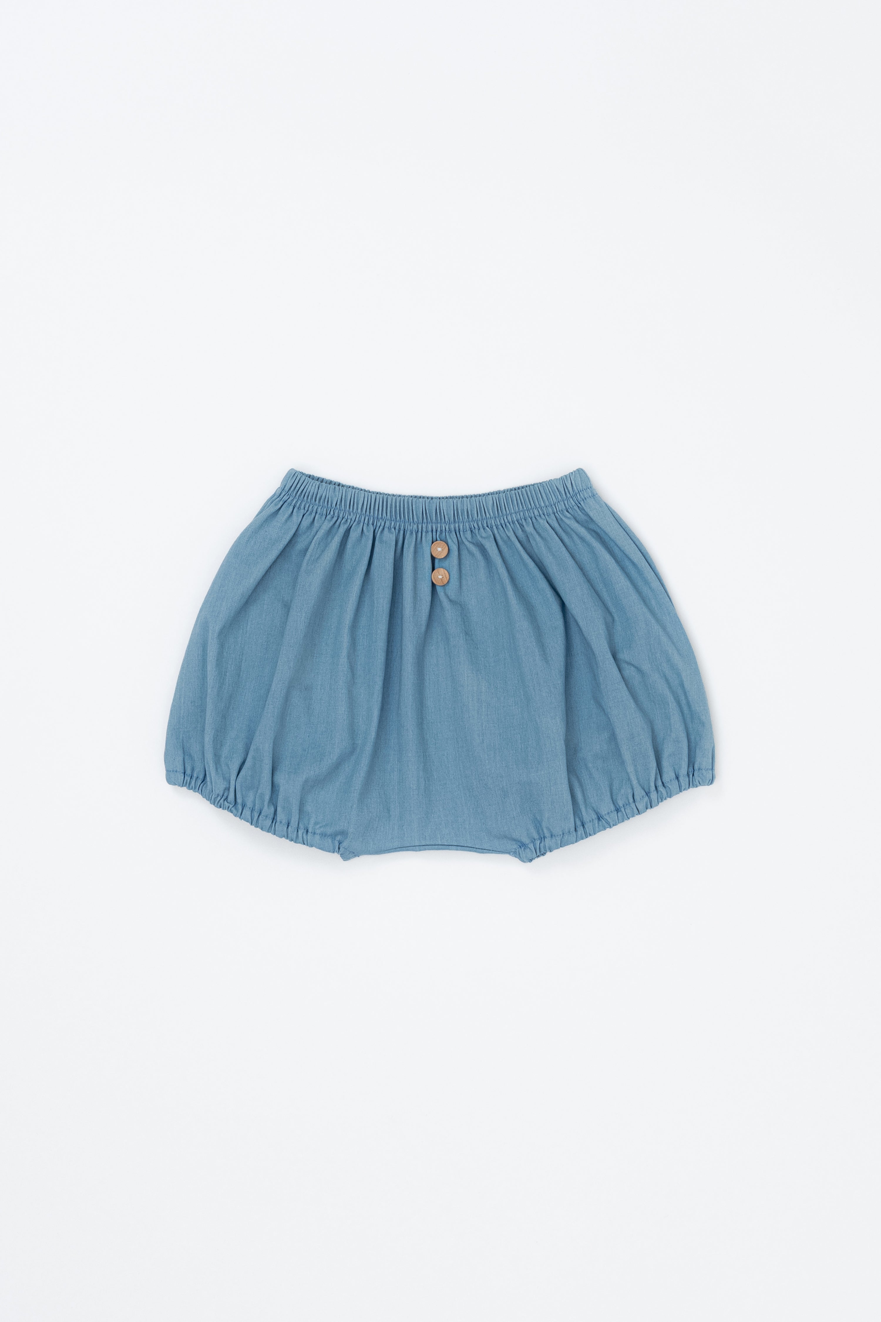 Avauma Linen Bloomer Sky product shot. Light blue baby bloomers with elastic waist and two wooden buttons on a white background.

