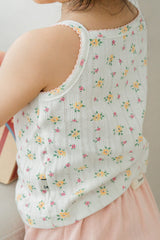 Back view of toddler in Avauma apricot daisy tank top and pink shorts
