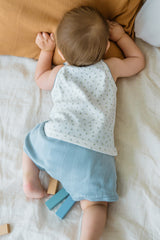 Toddler lying down in Avauma blue picot tank set – cozy dailywear with floral print
