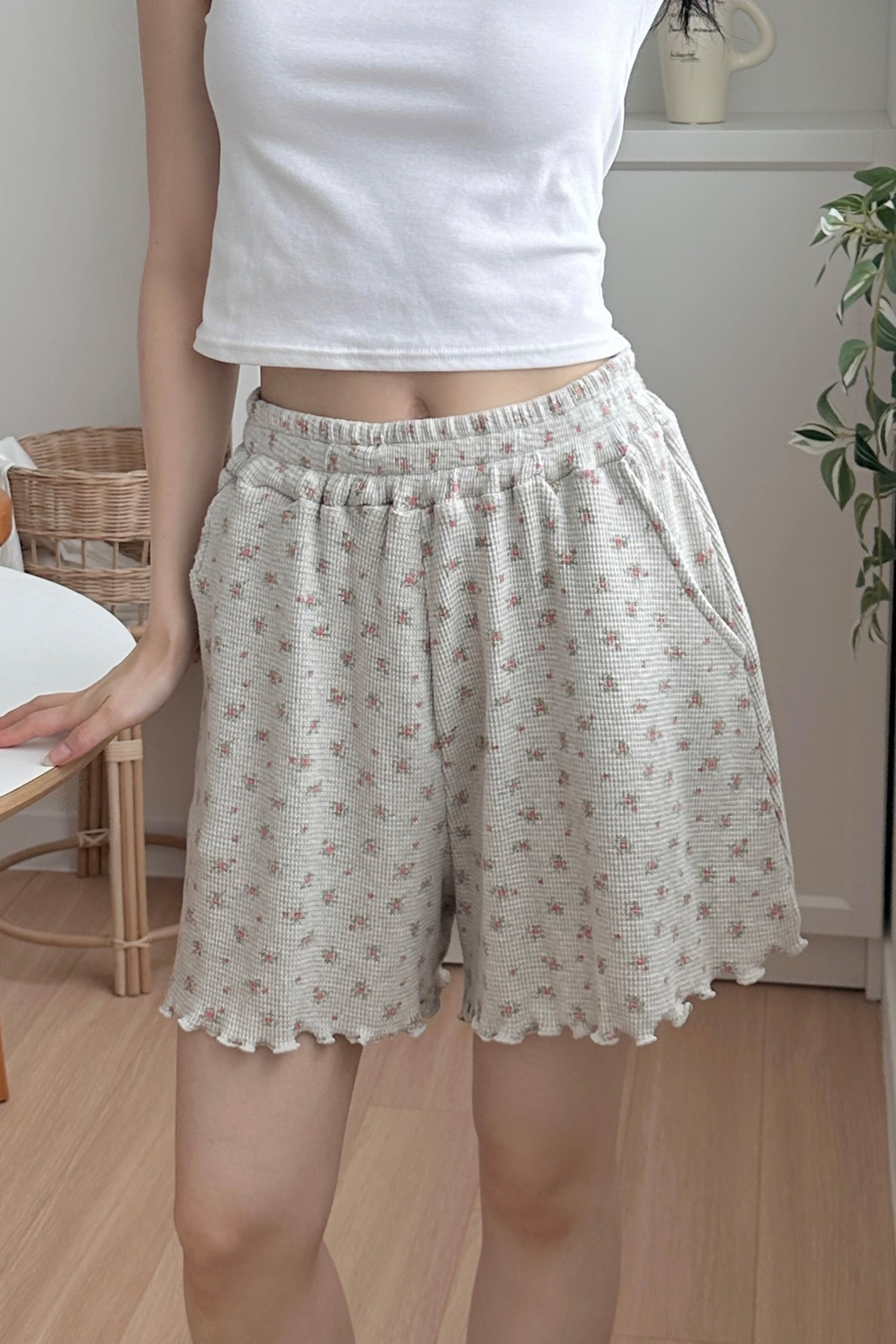 Model wearing Avauma Petitbloom mom shorts in rosy cream, styled with white top.

