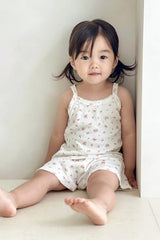 Baby girl sitting on floor wearing Avauma rose belle floral picnic tank top and frill shorts

