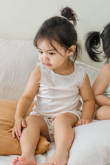 Toddler in Avauma vanilla cream tank top, playing on bed – cute summer outfit for kids