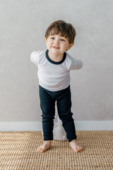 Smiling toddler wearing Avauma's Coco Classic Long Sleeve Set in Black Moon color - stylish and comfortable baby loungewear, ideal for playtime and sleepwear.