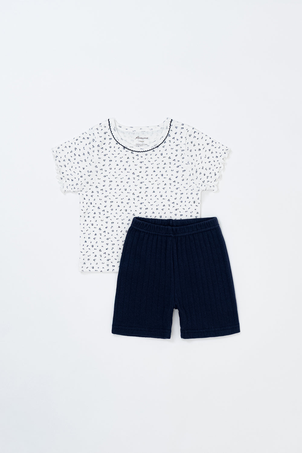 Avauma breeze garden setup indigo whisper - baby short sleeve floral top and navy shorts flatlay product image

