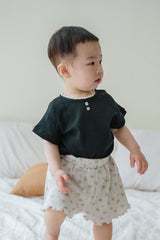 Toddler Boy Wearing Avauma Le Petite Classic Black Short Sleeve T-Shirt and Floral Shorts, Unisex Baby Outfit

