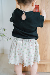 Back Detail of Avauma Le Petite Classic Black Puff Sleeve Short Sleeve Top with Keyhole Button, Paired with Skirt

