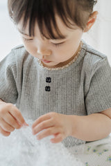 Close-up of Avauma Le Petite Soft Gray Short Sleeve Top with Buttons, Soft Knit Material for Summer

