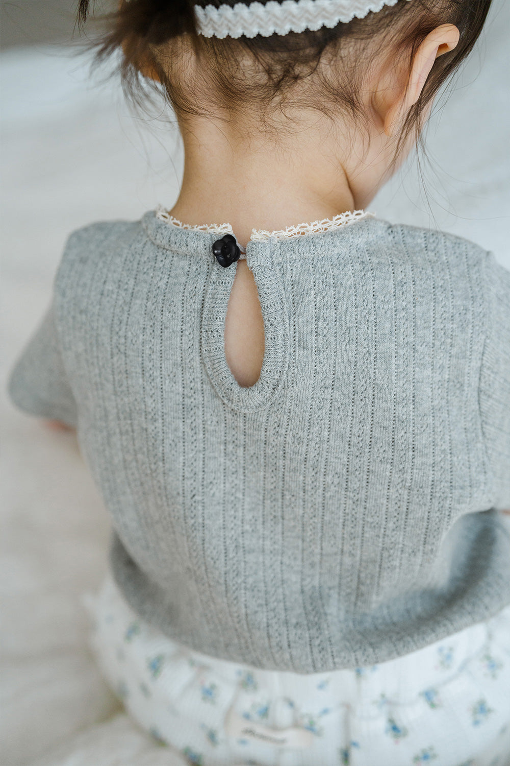 Back Detail of Avauma Le Petite Soft Gray Puff Sleeve Knit Top with Keyhole Button Design

